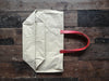 TOTELY BUCKET in BEIGE canvas and scarlet red shoulder straps